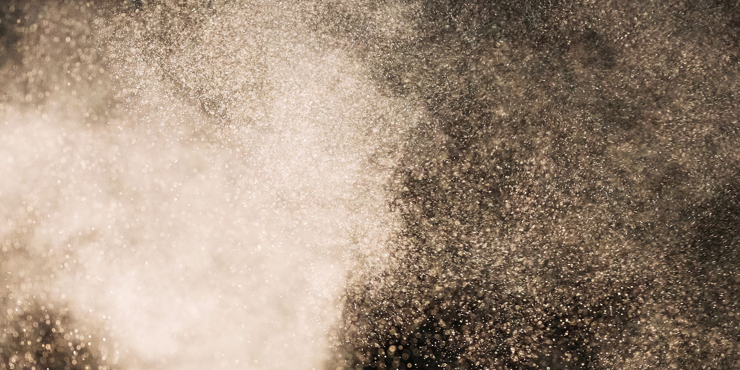 Cloud of fine white powder on black